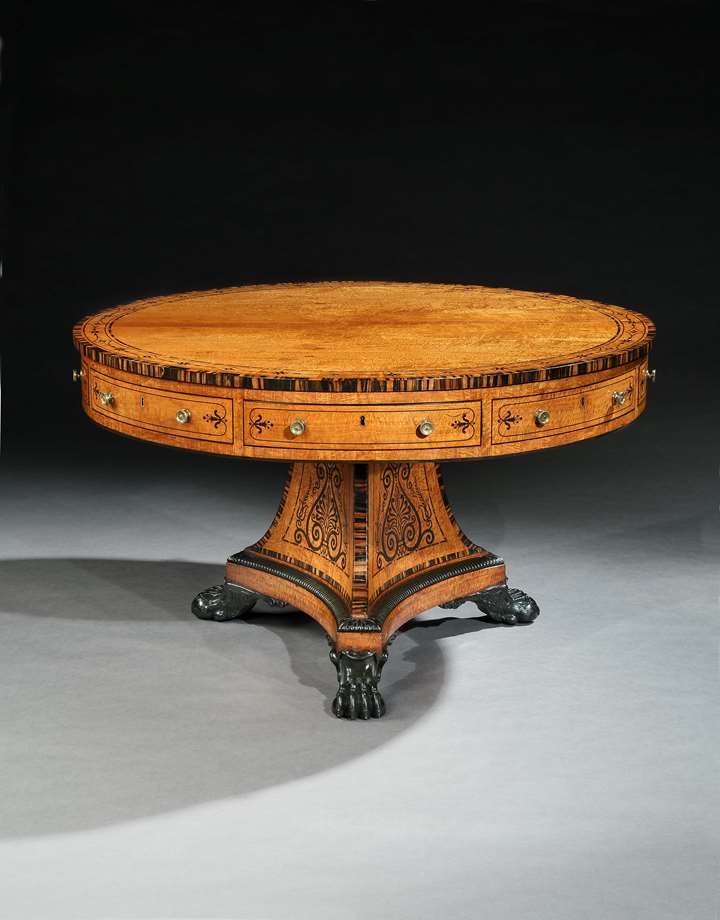 A regency satinwood and calamander drum table
